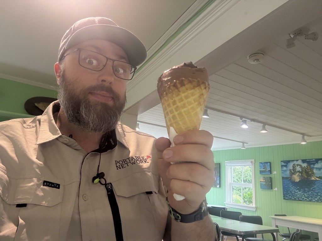 Selfie, wearing a "Portable.Network" shirt, and I'm holding an ice cream cone that is doomed.